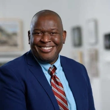 A man in a blue suit and red tie.